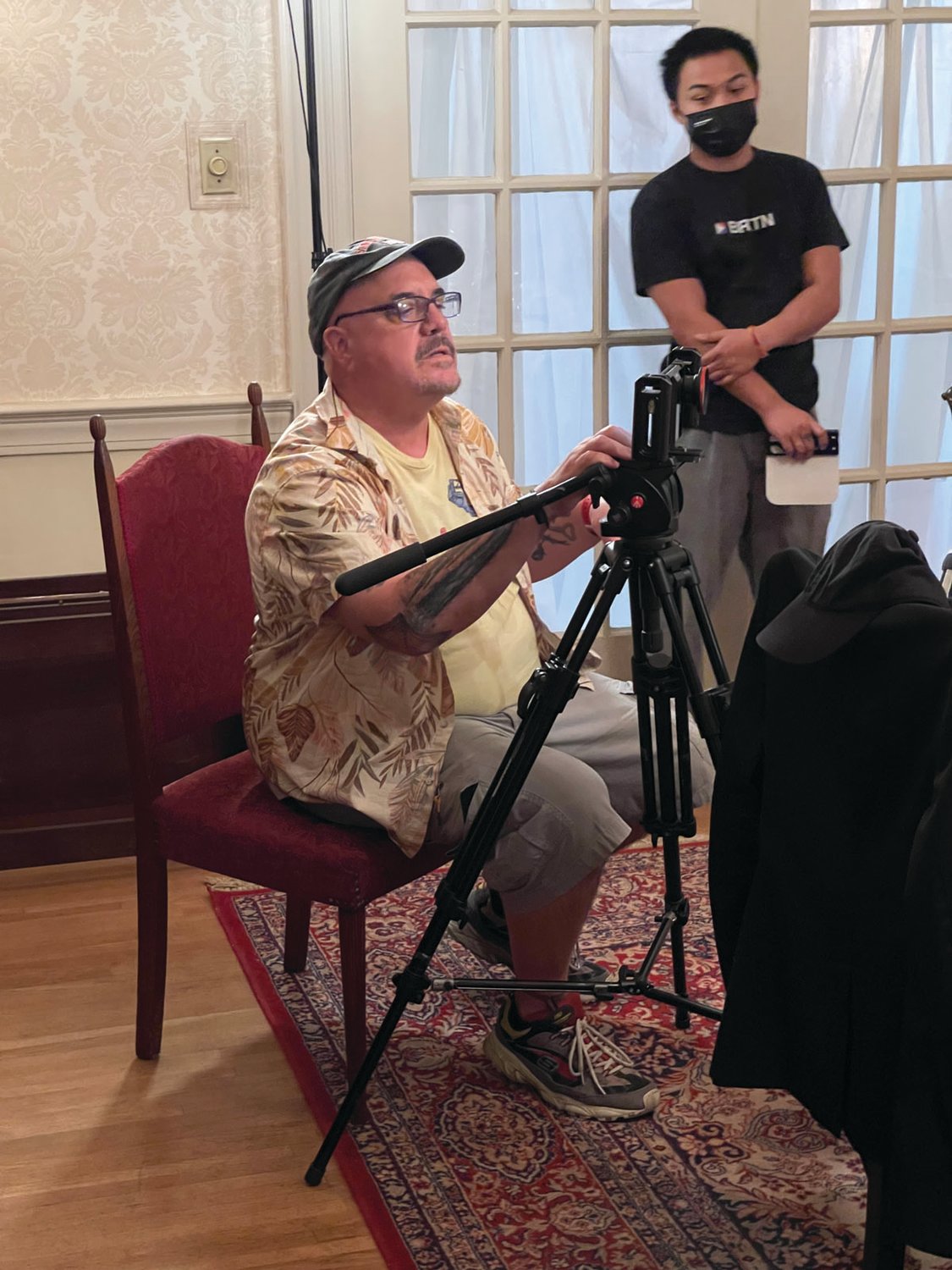 BEHIND THE LENS: Sean Michael Beyer, director of “Poor Paul,” prepares for a shoot in the dining room at Sprague Mansion on Friday.